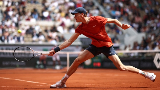 Italy's Jannik Sinner plays a backhand return to US Christopher Eubanks during their men's singles match on Court Suzanne-Lenglen on day two of the French Open tennis tournament at the Roland Garros Complex in Paris on May 27, 2024. (Photo by Anne-Christine POUJOULAT / AFP)