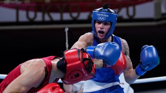 TOKYO, JAPAN - JULY 28: Caroline Veyre (red) of Canada exchanges punches with Irma Testa of Italy during the Women's Feather (54-57kg) quarter final on day five of the Tokyo 2020 Olympic Games at Kokugikan Arena on July 28, 2021 in Tokyo, Japan. (Photo by Frank Franklin - Pool/Getty Images)