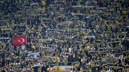 (FILES) Fenerbahce's fans cheer for their team during the UEFA Europa Conference League quarter-final second leg football match between Fenerbahce (TUR) and Olympiakos (GRE) at the Fenerbahce Sukru Aracoglu Stadium,  in Istanbul on April 18, 2024. The Turkish championship will be decided on May 18, 2024 during the football match between Fenerbahce and Galatasaray, in Istanbul. "Fener" must win at all costs to retain the chance to win the championship, which they have been denied for a decade, on May 18, 2024. (Photo by Ozan KOSE / AFP)