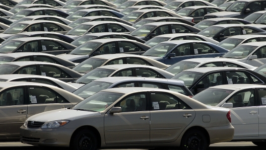 File - Toyota cars await shipping at the Toyota Logistics parking lot at the Long Beach Port on March 10, 2004, in Long Beach, Calif. Toyota and General Motors are telling the owners of about 61,000 older Corolla, Matrix, RAV4 and Pontiac Vibe models to stop driving them because their Takata air bag inflators are at risk of exploding and hurling shrapnel.(AP Photo/Damian Dovarganes, File)