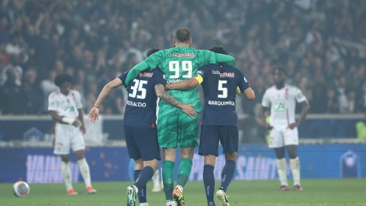 Paris Saint-Germain's Brazilian defender #35 Lucas Beraldo (CL), Paris Saint-Germain's Italian goalkeeper #99 Gianluigi Donnarumma (C) and Paris Saint-Germain's Brazilian defender #05 Marquinhos (CR) celebrate winning the French Cup Final football match between Olympique Lyonnais (OL) and Paris Saint-Germain (PSG) at the Stade Pierre-Mauroy, in Villeneuve-d'Ascq, northern France on May 25, 2024. (Photo by FRANCK FIFE / AFP)