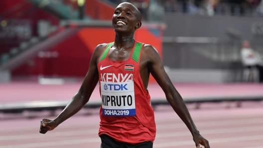 Kenya's Rhonex Kipruto celebrates finishing third in the Men's 10,000m final at the 2019 IAAF Athletics World Championships at the Khalifa International stadium in Doha on October 6, 2019. Kenya's 10 kilometres road race record holder Rhonex Kipruto has been banned for six years for doping and his world mark cancelled, the Athletics Integrity Unit (AIU) announced on Wednesday. (Photo by ANDREJ ISAKOVIC / AFP)