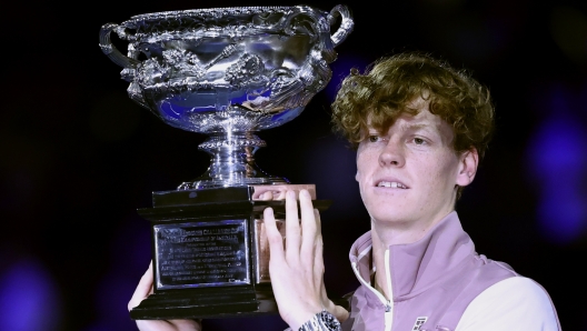 FILE - Jannik Sinner of Italy holds the Norman Brookes Challenge Cup aloft after defeating Daniil Medvedev of Russia in the men's singles final at the Australian Open tennis championships at Melbourne Park, in Melbourne, Australia, Sunday, Jan. 28, 2024. Sinner made his debut at No. 1 in the ATP rankings on Monday, June 10, moving up one spot to replace the injured Novak Djokovic. (AP Photo/Asanka Brendon Ratnayake, File)