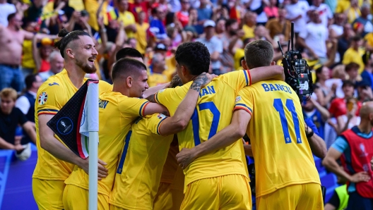 Romania's players celebrate scoring their third goal during the UEFA Euro 2024 Group E football match between Romania and Ukraine at the Munich Football Arena in Munich on June 17, 2024. (Photo by Tobias SCHWARZ / AFP)