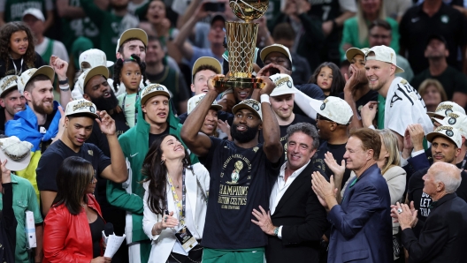 BOSTON, MASSACHUSETTS - JUNE 17: Jaylen Brown #7 of the Boston Celtics holds up the Larry OBrien Championship Trophy after Boston's 106-88 win against the Dallas Mavericks in Game Five of the 2024 NBA Finals at TD Garden on June 17, 2024 in Boston, Massachusetts. NOTE TO USER: User expressly acknowledges and agrees that, by downloading and or using this photograph, User is consenting to the terms and conditions of the Getty Images License Agreement.   Adam Glanzman/Getty Images/AFP (Photo by Adam Glanzman / GETTY IMAGES NORTH AMERICA / Getty Images via AFP)