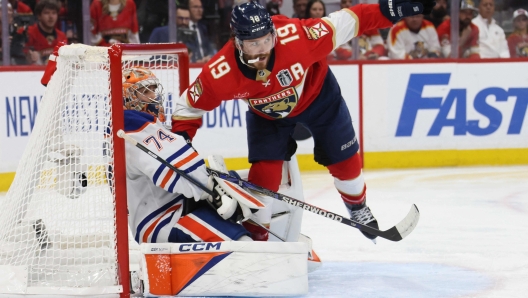 SUNRISE, FLORIDA - JUNE 18: Matthew Tkachuk #19 of the Florida Panthers collides with Stuart Skinner #74 of the Edmonton Oilers during the third period in Game Five of the 2024 Stanley Cup Final at Amerant Bank Arena on June 18, 2024 in Sunrise, Florida.   Bruce Bennett/Getty Images/AFP (Photo by BRUCE BENNETT / GETTY IMAGES NORTH AMERICA / Getty Images via AFP)