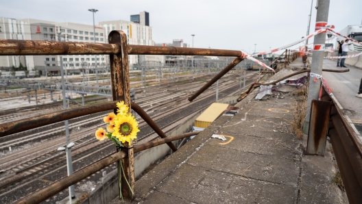 Flowers in the place where a bus with people on board fell from an elevated section ending up on the railway track that runs alongside the road, in Mestre, near Venice, Italy, 04 October 2023. Venice Prefect Michele Di Bari said Wednesday that the local council and the Veneto regional government were requesting the declaration of three days of mourning after 21 people died and 15 were injured on Tuesday when a bus plunged from an overpass in the Mestre district of the city. Marco Albertini 2023