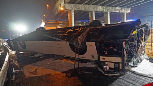 Rescue personnel work at the site where a passenger bus with people on board fell from an elevated section ending up on the railway track that runs alongside the road in Mestre, near Venice, Italy, 03 October 2023. There are at least 21 confirmed deaths and 15 injured.  ANSA/ANDREA MEROLA