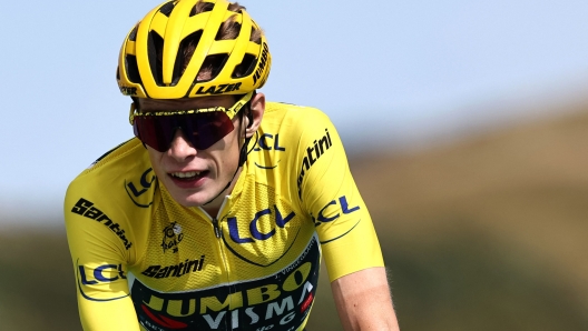 (FILES) Jumbo-Visma's Danish rider Jonas Vingegaard wearing the overall leader's yellow jersey crosses the finish line at the end of the 20th stage of the 110th edition of the Tour de France cycling race 133 km between Belfort and Le Markstein Fellering, in Eastern France, on July 22, 2023. Two-time defending champion Jonas Vingegaard will ride in this year's Tour de France after recovering from the serious injuries he suffered earlier in the season his team Visma-Lease a Bike announced on June 20, 2024. (Photo by Anne-Christine POUJOULAT / AFP)