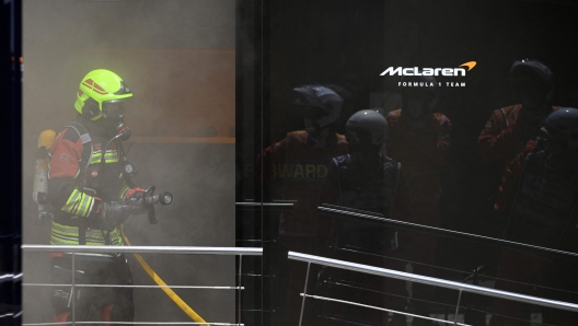 Firefighters work to extinguish a fire at McLaren motor-home at the Circuit de Catalunya on June 22, 2024 in Montmelo, on the outskirts of Barcelona, during the Spanish Formula One Grand Prix. (Photo by Josep LAGO / AFP)