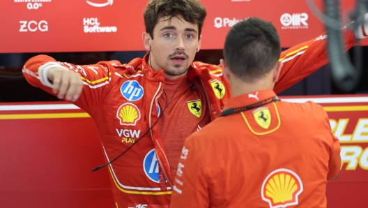 Ferrari's Monegasque driver Charles Leclerc is pictured in the box as he prepares to compete in the qualification session at the Circuit de Catalunya on June 22, 2024 in Montmelo, on the outskirts of Barcelona, during the Spanish Formula One Grand Prix. (Photo by Thomas COEX / POOL / AFP)