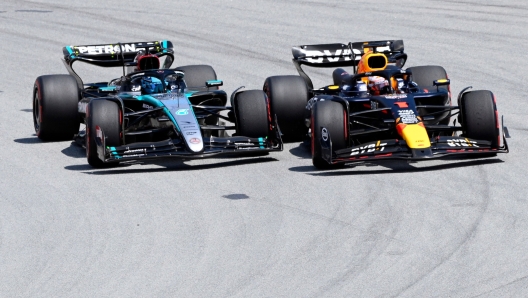 Red Bull's Dutch driver Max Verstappen (R) overtakes Mercedes' British driver George Russell during the Spanish Formula One Grand Prix at the Circuit de Catalunya on June 23, 2024 in Montmelo, on the outskirts of Barcelona. (Photo by Josep LAGO / AFP)