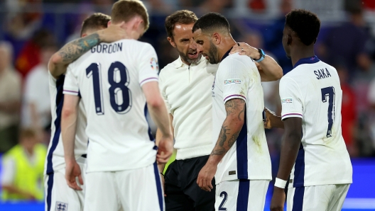 COLOGNE, GERMANY - JUNE 25: Gareth Southgate, Head Coach of England, speaks with Kyle Walker of England after the UEFA EURO 2024 group stage match between England and Slovenia at Cologne Stadium on June 25, 2024 in Cologne, Germany. (Photo by Richard Pelham/Getty Images)