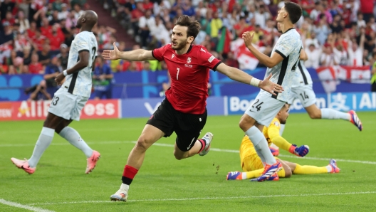 epa11440101 Khvicha Kvaratskhelia of Georgia celebrates after scoring the 1-0 goal during the UEFA EURO 2024 group F soccer match between Georgia and Portugal, in Gelsenkirchen, Germany, 26 June 2024.  EPA/FRIEDEMANN VOGEL