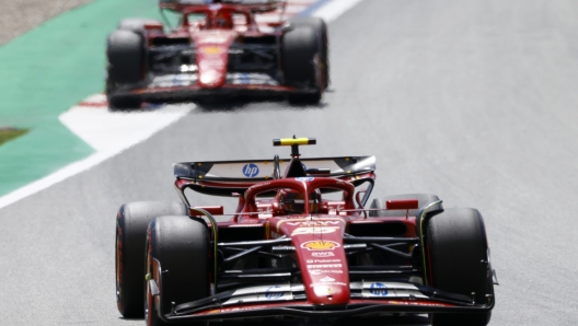 Ferrari driver Carlos Sainz of Spain steers his car followed by Ferrari driver Charles Leclerc of Monaco during the Formula 1 Spanish Grand Prix at the Barcelona Catalunya racetrack in Montmelo, near Barcelona, Spain, Sunday, June 23, 2024. (AP Photo/Joan Monfort)