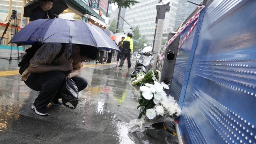 A man prays for victims at a car accident scene near Seoul City Hall in downtown Seoul, South Korea, Tuesday, July 2, 2024. A car hit several people Monday night, after reportedly going in the wrong direction and colliding with two other cars killing multiple people. The driver will be investigated on allegations of accidental homicide, police said Tuesday. (AP Photo/Ahn Young-joon)