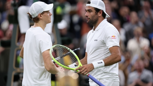 LONDON, ENGLAND - JULY 03: Jannik Sinner of Italy meets Matteo Berrettini of Italy at the net following victory in his Gentlemen's Singles second round match during day three of The Championships Wimbledon 2024 at All England Lawn Tennis and Croquet Club on July 03, 2024 in London, England. (Photo by Clive Brunskill/Getty Images)