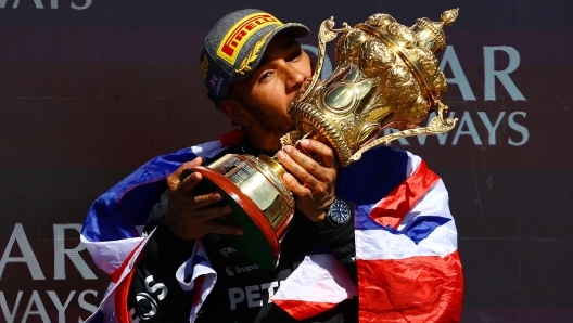 NORTHAMPTON, ENGLAND - JULY 07: Race winner Lewis Hamilton of Great Britain and Mercedes celebrates on the podium during the F1 Grand Prix of Great Britain at Silverstone Circuit on July 07, 2024 in Northampton, England. (Photo by Mark Thompson/Getty Images) *** BESTPIX ***