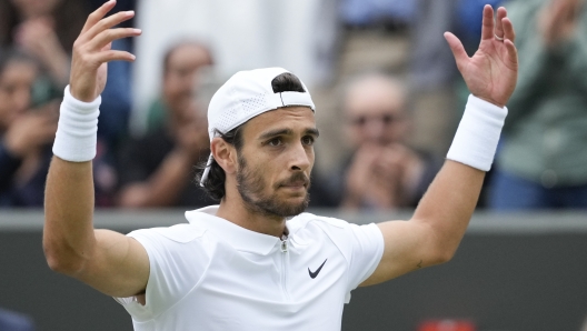 Lorenzo Musetti of Italy celebrates after defeating Giovanni Mpetshi Perricard of France in their fourth round match at the Wimbledon tennis championships in London, Monday, July 8, 2024. (AP Photo/Mosa'ab Elshamy)