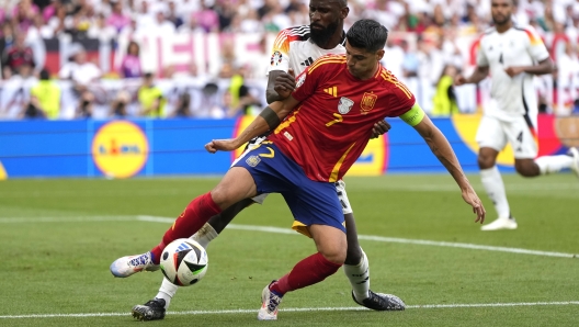 Spain's Alvaro Morata, right, and Germany's Antonio Ruediger vie for the ball during a quarter final match between Germany and Spain at the Euro 2024 soccer tournament in Stuttgart, Germany, Friday, July 5, 2024. (AP Photo/Matthias Schrader)