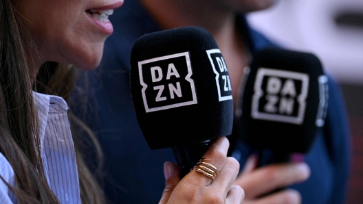 Journlist of broadcaster DAZN report from the paddock during the third practice session of the Formula One Monaco Grand Prix on May 25 2024 at the Circuit de Monaco, on the eve of the race. (Photo by NICOLAS TUCAT / AFP)