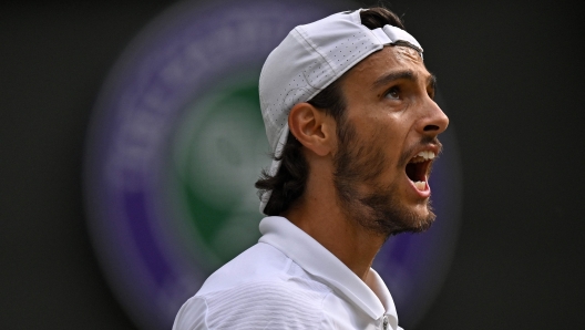 Italy's Lorenzo Musetti celebrates winning the third set against US player Taylor Fritz during their men's singles quarter-finals tennis match on the tenth day of the 2024 Wimbledon Championships at The All England Lawn Tennis and Croquet Club in Wimbledon, southwest London, on July 10, 2024. (Photo by ANDREJ ISAKOVIC / AFP) / RESTRICTED TO EDITORIAL USE