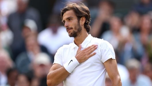 LONDON, ENGLAND - JULY 10: Lorenzo Musetti of Italy celebrates winning match point against Taylor Fritz of United States in the Gentlemen's Singles Quarter Final match during day ten of The Championships Wimbledon 2024 at All England Lawn Tennis and Croquet Club on July 10, 2024 in London, England. (Photo by Julian Finney/Getty Images)