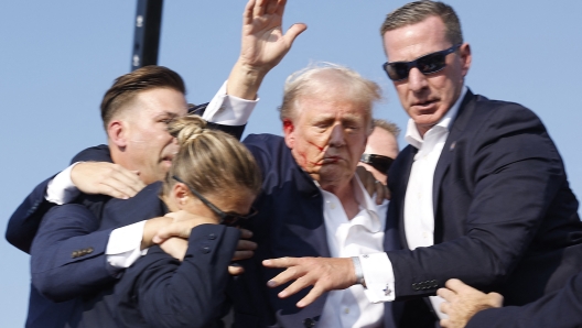 BUTLER, PENNSYLVANIA - JULY 13: Republican presidential candidate former President Donald Trump is rushed offstage during a rally on July 13, 2024 in Butler, Pennsylvania.   Anna Moneymaker/Getty Images/AFP (Photo by Anna Moneymaker / GETTY IMAGES NORTH AMERICA / Getty Images via AFP)