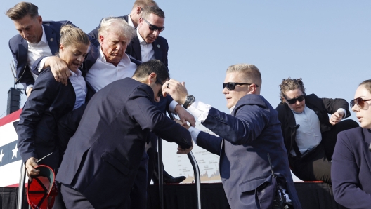 BUTLER, PENNSYLVANIA - JULY 13: Republican presidential candidate former President Donald Trump is rushed offstage during a rally on July 13, 2024 in Butler, Pennsylvania.   Anna Moneymaker/Getty Images/AFP (Photo by Anna Moneymaker / GETTY IMAGES NORTH AMERICA / Getty Images via AFP)