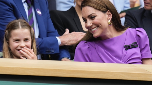 Kate, Princess of Wales and Princess Charlotte react on Centre Court ahead of the men's singles final at the Wimbledon tennis championships in London, Sunday, July 14, 2024. (AP Photo/Kirsty Wigglesworth)