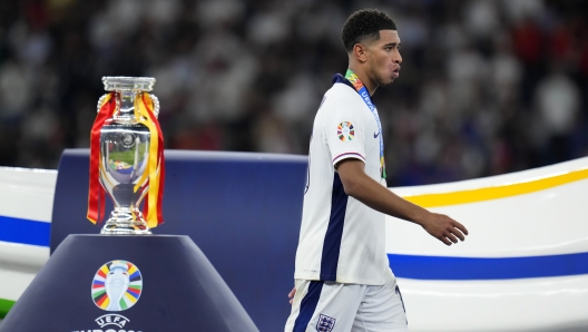 England's Jude Bellingham walks past the trophy after the final match between Spain and England at the Euro 2024 soccer tournament in Berlin, Germany, Sunday, July 14, 2024. Spain won 2-1. (AP Photo/Manu Fernandez)