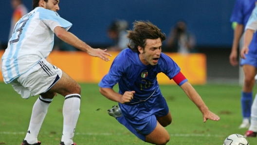 Italy's Andrea Pirlo (R) falls in front of Argentina's Nicolas Medina (L) during the semi-finals soccer match at Karaiskaki Stadium 24 August 2004 for the Athens 2004 Olympics Games.     AFP PHOTO / Jacques DEMARTHON (Photo by JACQUES DEMARTHON / AFP)