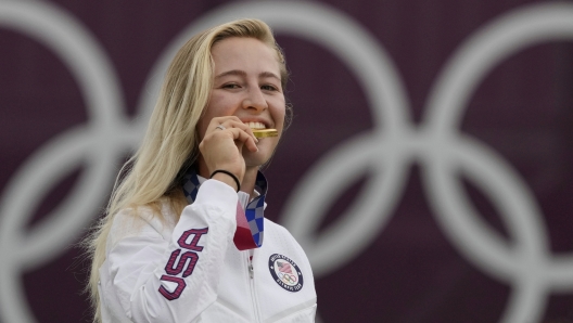 FILE - Nelly Korda, of the United States, bites her gold medal of the women's golf event at the 2020 Summer Olympics, Saturday, Aug. 7, 2021, at the Kasumigaseki Country Club in Kawagoe, Japan. Korda will be a strong favorite to win another gold at the Paris Games. (AP Photo/Andy Wong, File)