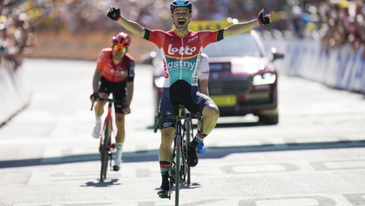 Belgium's Victor Campenaerts celebrates as he crosses the finish line ahead of France's Matteo Vercher, hidden behind Campenaerts, and Poland's Michal Kwiatkowski, left, to win during the eighteenth stage of the Tour de France cycling race over 179.5 kilometers (111.5 miles) with start in Gap and finish in Barcelonette, France, Thursday, July 18, 2024. (AP Photo/Jerome Delay)