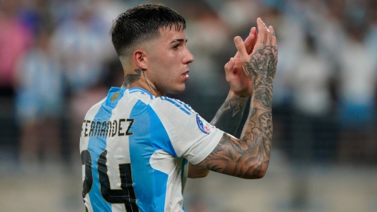 (FILES) Argentina's midfielder #24 Enzo Fernandez celebrates his team's victory during the Conmebol 2024 Copa America tournament semi-final football match between Argentina and Canada at MetLife Stadium, in East Rutherford, New Jersey on July 9, 2024. Chelsea Football Club launched disciplinary proceedings against Argentine midfielder Enzo Fernandez on July 17, 2024, following a racist song directed at players from the French national soccer team. (Photo by EDUARDO MUNOZ / AFP)