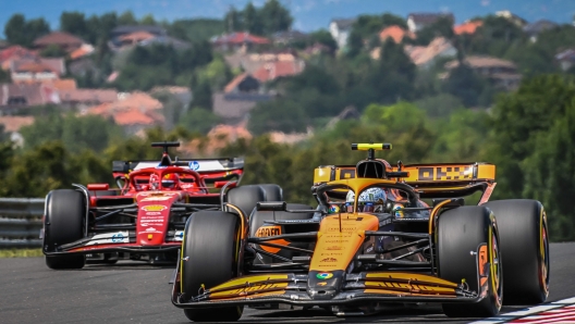 McLaren's British driver Lando Norris (R) drives during the first practice session at the Hungaroring race track in Mogyorod near Budapest on July 19, 2024, ahead of the Formula One Hungarian Grand Prix. (Photo by FERENC ISZA / AFP)