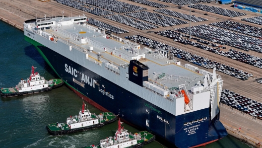 TOPSHOT - This aerial photograph taken on May 15, 2024 shows cars for export waiting to be loaded on the "SAIC Anji Eternity", a domestically manufactured vessel intended to export Chinese automobiles, at Yantai port, in eastern China's Shandong province. (Photo by AFP) / China OUT