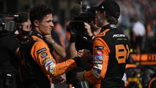 McLaren driver Lando Norris of Britain, left, congratulates McLaren driver Oscar Piastri of Australia on his win at the Hungarian Formula One Grand Prix race at the Hungaroring racetrack in Mogyorod, Hungary, Sunday, July 21, 2024. (AP Photo/Denes Erdos)