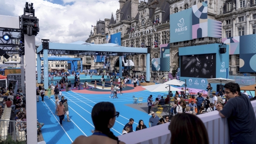 The square of the Hotel de Ville, or town hall, is transformed into a fan zone ahead of the 2024 Summer Olympics, Sunday, July 21, 2024, in Paris, France. (AP Photo/David Goldman)