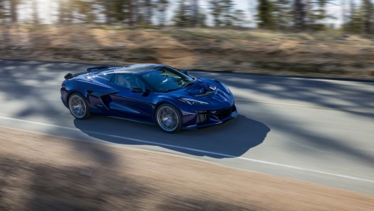 Passenger side view of Chevrolet Corvette ZR1 Convertible in Hysteria Purple driving down a mountain road. Preproduction model shown. Actual production model may vary.