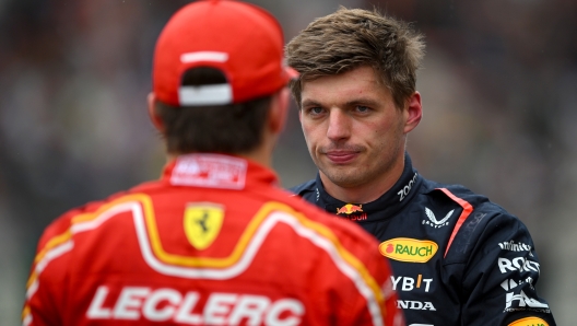 SPA, BELGIUM - JULY 27: Pole position qualifier Max Verstappen of the Netherlands and Oracle Red Bull Racing talks with Second placed qualifier Charles Leclerc of Monaco and Ferrari in parc ferme during qualifying ahead of the F1 Grand Prix of Belgium at Circuit de Spa-Francorchamps on July 27, 2024 in Spa, Belgium. (Photo by Rudy Carezzevoli/Getty Images)