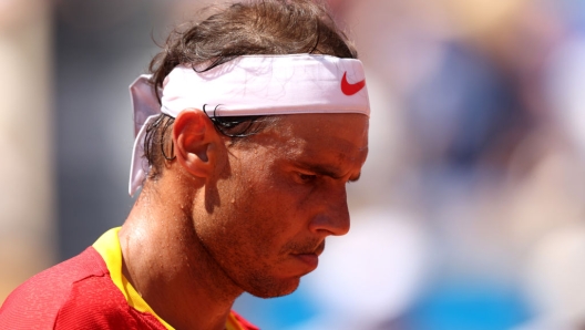 PARIS, FRANCE - JULY 29: Rafael Nadal of Team Spain looks on against Novak Djokovic of Team Serbia during the Men's Singles second round match on day three of the Olympic Games Paris 2024 at Roland Garros on July 29, 2024 in Paris, France. (Photo by Clive Brunskill/Getty Images)