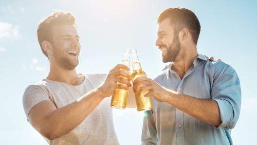 Group of people having barbecue party drinking beer