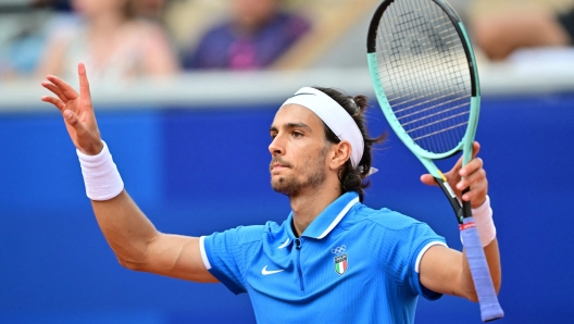 Italy's Lorenzo Musetti reacts to beating France's Gael Monfils in their men's singles first round tennis match on Court Suzanne-Lenglen at the Roland-Garros Stadium at the Paris 2024 Olympic Games, in Paris on July 28, 2024. (Photo by Martin  BERNETTI / AFP)