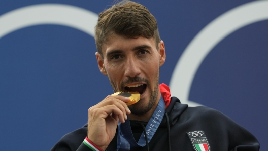 Gold medalist Giovanni de Gennaro of Italy poses during a medals ceremony for the men's kayak single finals at the 2024 Summer Olympics, Thursday, Aug. 1, 2024, in Vaires-sur-Marne, France. (AP Photo/Kirsty Wigglesworth)