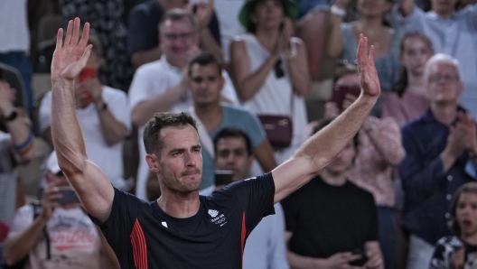 Andy Murray of Britain cries and waves to the spectators after he and his partner Daniel Evans defeated by Taylor Fritz and Tommy Paul of the United States in the men's doubles quarterfinals tennis match, at the 2024 Summer Olympics, Thursday, Aug.1, 2024, at the Roland Garros stadium in Paris, France. (AP Photo/Andy Wong)