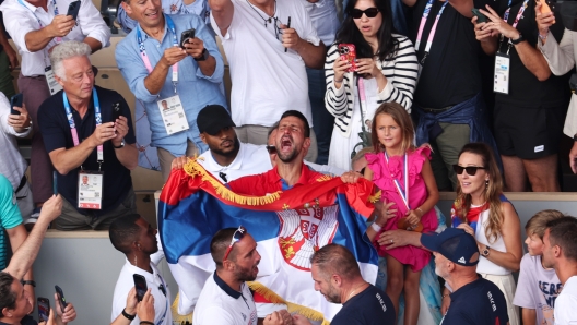 PARIS, FRANCE - AUGUST 04: Novak Djokovic of Team Serbia celebrates victory in his players box during the Men's Singles Gold medal match against Carlos Alcaraz of Team Spain on day nine of the Olympic Games Paris 2024 at Roland Garros on August 04, 2024 in Paris, France. (Photo by Matthew Stockman/Getty Images)