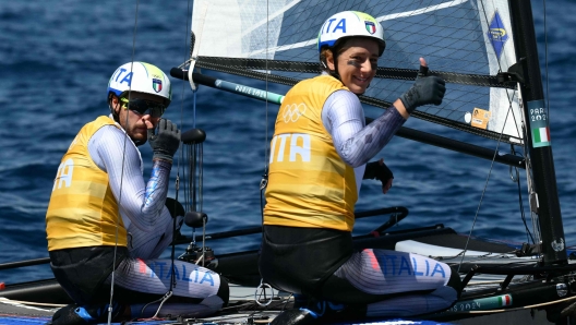 Italy's duo Ruggero Tita and Catarina Marianna Banti react after winning race 7 of the mixed Nacra 17 multihull event during the Paris 2024 Olympic Games sailing competition at the Roucas-Blanc Marina in Marseille on August 5, 2024. (Photo by Christophe SIMON / AFP)