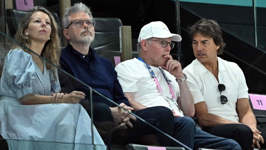 (FILES) US actor Tom Cruise (R) speaks with Warner Bros CEO David Zaslav (2ndR) next to US film director Christopher McQuarrie (2ndL) and his wife costume designer Heather McQuarrie as they attend the artistic gymnastics women's qualification during the Paris 2024 Olympic Games at the Bercy Arena in Paris, on July 28, 2024. Hollywood has not waited for the Los Angeles 2028 Olympics Games: various US VIPs have been spotted in the stands at sporting events, now Hollywood just has to take up the challenge in four years' time, in Paris, on July 31, 2024. (Photo by Lionel BONAVENTURE / AFP)