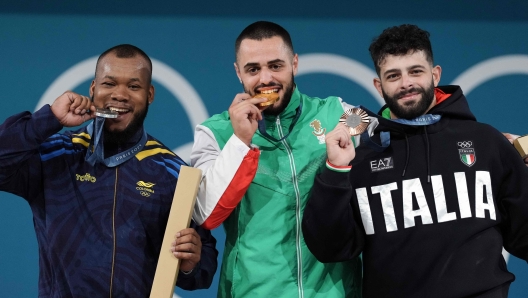 Gold medallist Bulgaria's Karlos May Nasar (C), silver medallist Colombia's Yeison Lopez (L) and bronze medallist Italy's Antonino Pizzolato (R) pose on the podium after the men's -89kg weightlifting event during the Paris 2024 Olympic Games at the South Paris Arena in Paris, on August 9, 2024. (Photo by Dimitar DILKOFF / AFP)